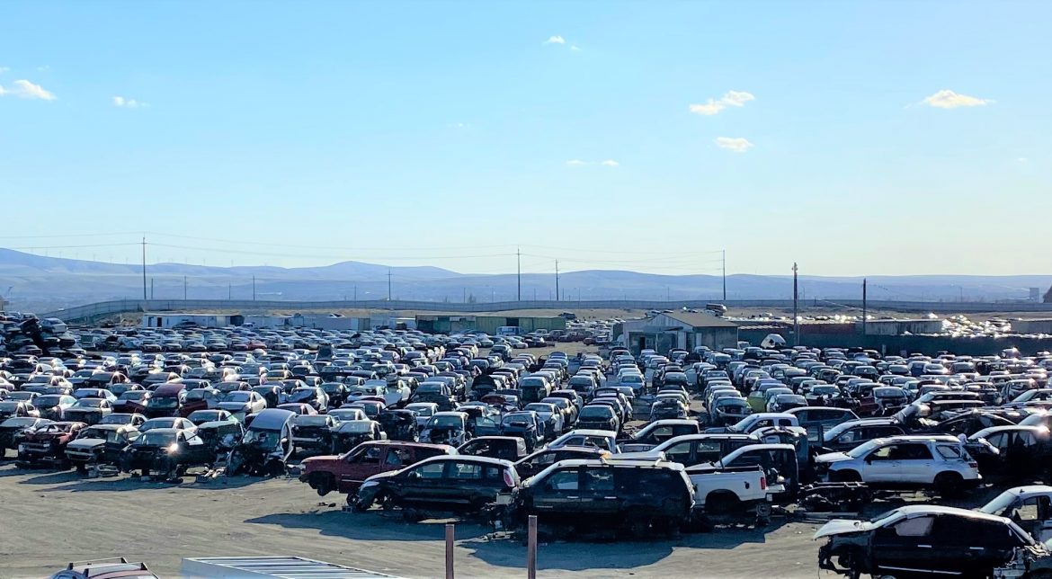 Large lot filled with parked used vehicles